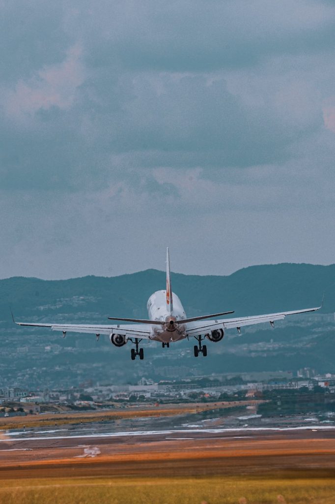 A large jetliner flying through a cloudy sky
