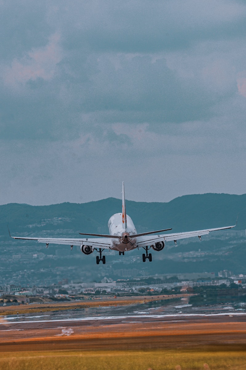 A large jetliner flying through a cloudy sky